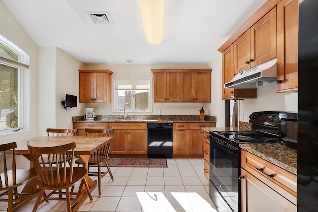 kitchen featuring decorative light fixtures, sink, dark stone countertops, light tile patterned floors, and black appliances