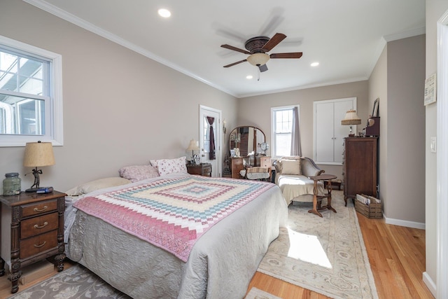 bedroom featuring ceiling fan, ornamental molding, and light hardwood / wood-style floors