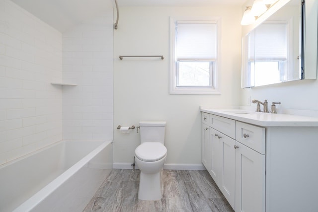 full bathroom featuring hardwood / wood-style flooring, vanity, a healthy amount of sunlight, and toilet