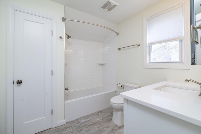 full bathroom with vanity, wood-type flooring, toilet, and tiled shower / bath