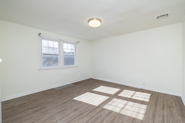 unfurnished room with dark hardwood / wood-style flooring