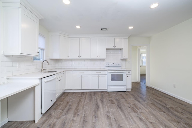 kitchen featuring white cabinetry, white appliances, sink, and light wood-type flooring