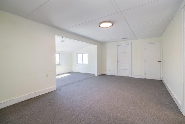 spare room with vaulted ceiling and carpet