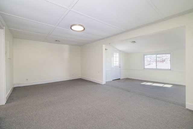 spare room with carpet floors and vaulted ceiling