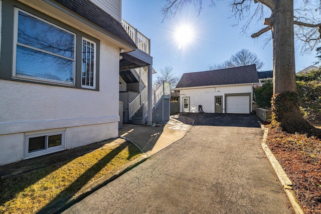 view of property exterior with an outbuilding and a garage