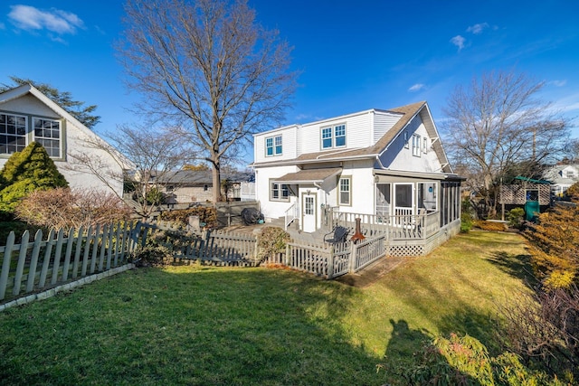 rear view of house with a yard