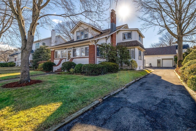 view of front of house featuring a garage and a front lawn