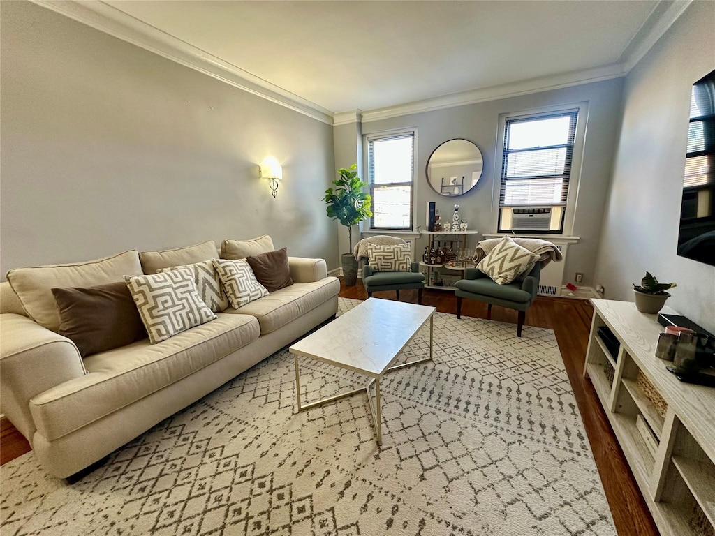 living room with hardwood / wood-style flooring, ornamental molding, and cooling unit