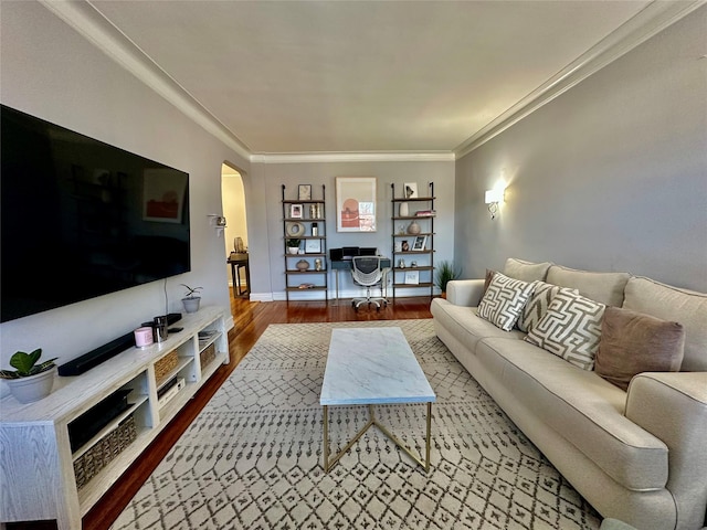 living room with wood-type flooring and ornamental molding