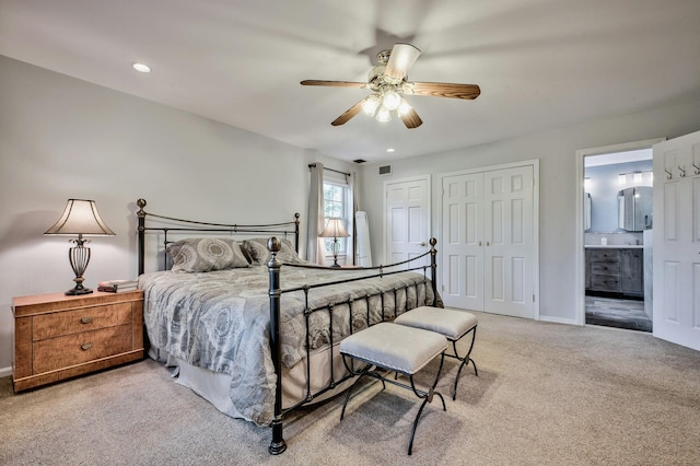 bedroom with carpet flooring, connected bathroom, and ceiling fan