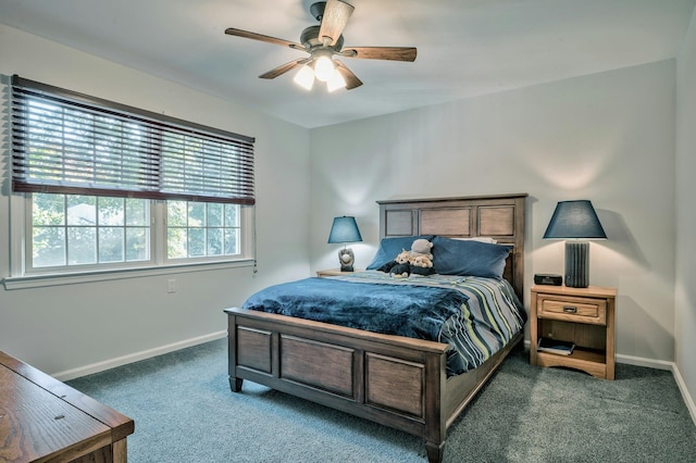 bedroom featuring ceiling fan and dark carpet