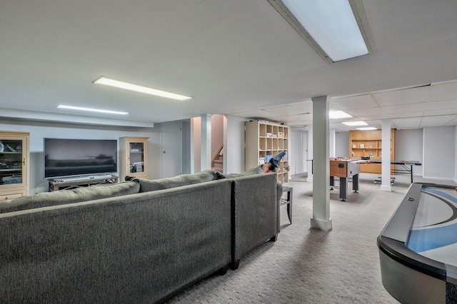 carpeted living room with a drop ceiling