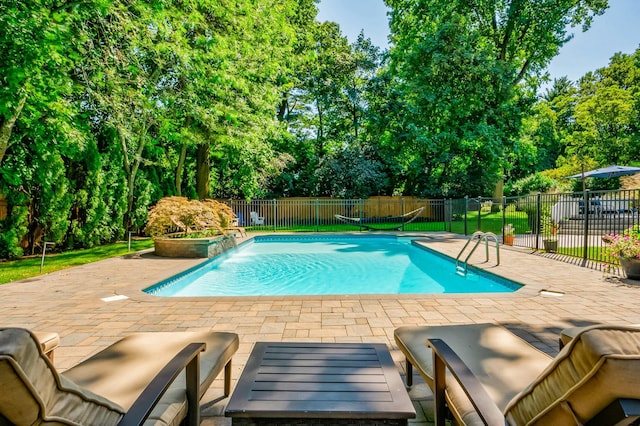 view of pool featuring pool water feature and a patio