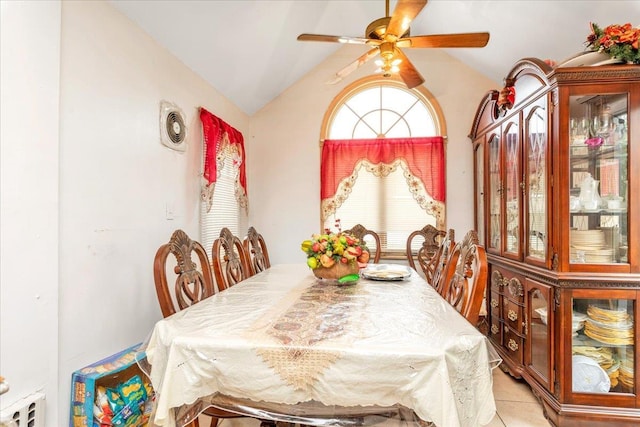 tiled dining room featuring vaulted ceiling and ceiling fan