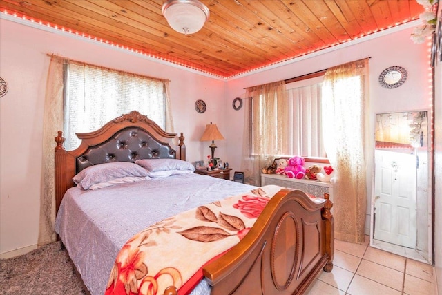 bedroom with light tile patterned floors and wooden ceiling