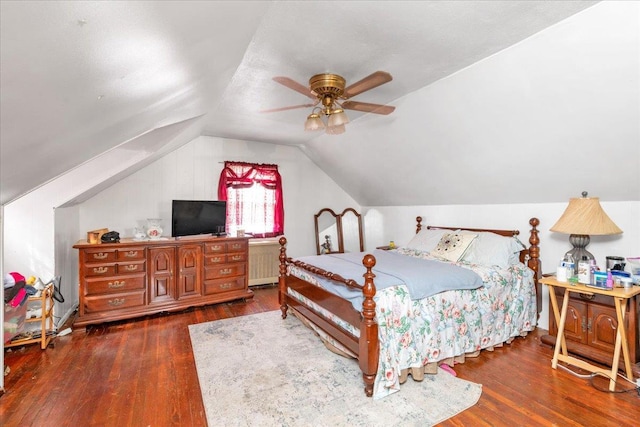 bedroom featuring dark hardwood / wood-style flooring, lofted ceiling, and ceiling fan