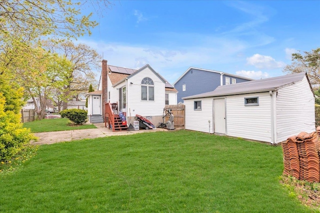 back of house featuring a lawn