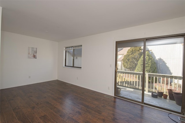 empty room with dark hardwood / wood-style flooring