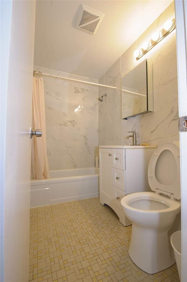 full bathroom featuring shower / tub combo, vanity, toilet, and tile walls