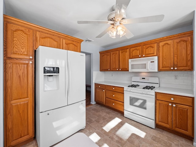 kitchen with white appliances, ceiling fan, and tasteful backsplash