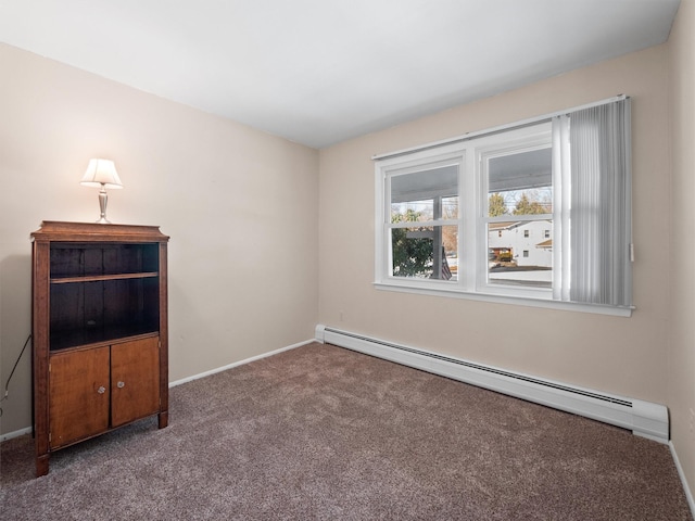 empty room with baseboard heating and carpet floors