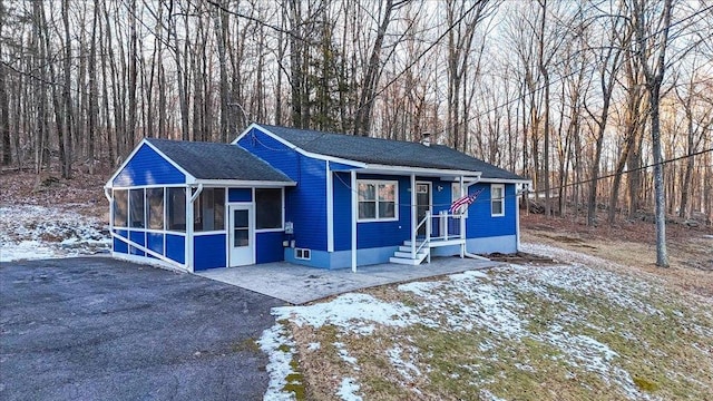 view of front of home with a sunroom