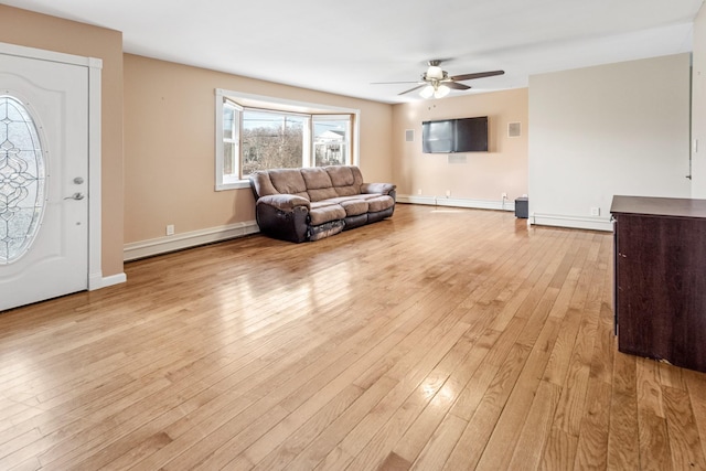 living room with ceiling fan, a baseboard heating unit, and light hardwood / wood-style floors