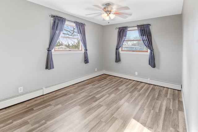 unfurnished room with light hardwood / wood-style flooring, a wealth of natural light, and ceiling fan