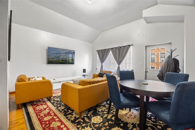 living room with hardwood / wood-style flooring and vaulted ceiling