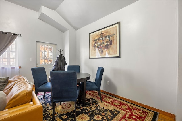 dining area with hardwood / wood-style flooring and lofted ceiling