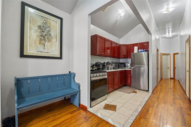 kitchen with light wood-type flooring and appliances with stainless steel finishes