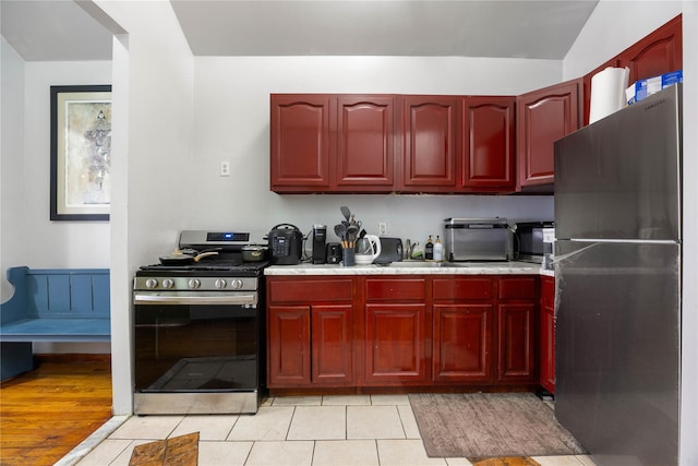 kitchen featuring stainless steel appliances and light tile patterned floors