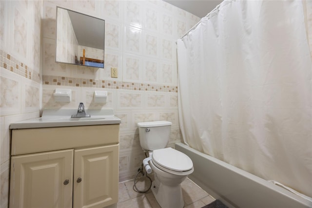 full bathroom featuring tile patterned floors, toilet, tile walls, vanity, and shower / bathtub combination with curtain