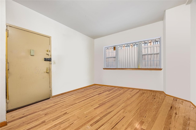 empty room with light hardwood / wood-style flooring