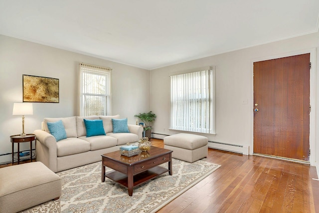 living room featuring a baseboard heating unit and hardwood / wood-style floors