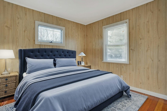 bedroom with hardwood / wood-style flooring and crown molding