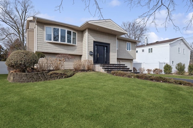 view of front of home with a garage and a front yard