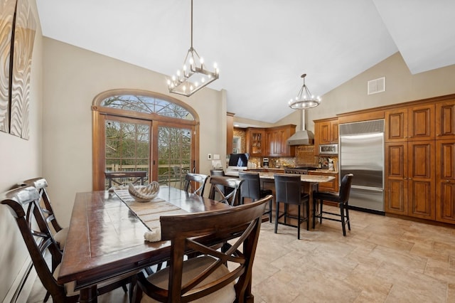 dining room featuring high vaulted ceiling and a notable chandelier