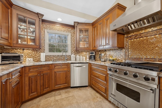 kitchen featuring sink, appliances with stainless steel finishes, backsplash, light stone countertops, and wall chimney exhaust hood