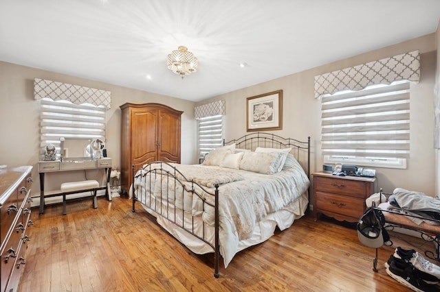 bedroom featuring light hardwood / wood-style flooring and a baseboard radiator