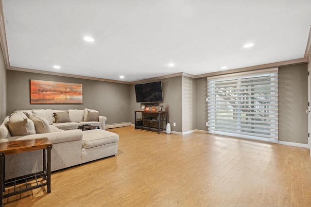 living room featuring ornamental molding, light wood-type flooring, and baseboard heating