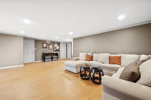 living room with ornamental molding and light hardwood / wood-style floors