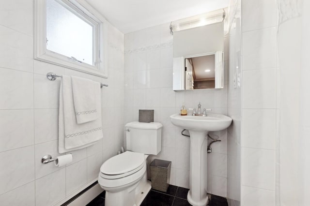 bathroom with tile walls, tile patterned floors, toilet, and baseboard heating