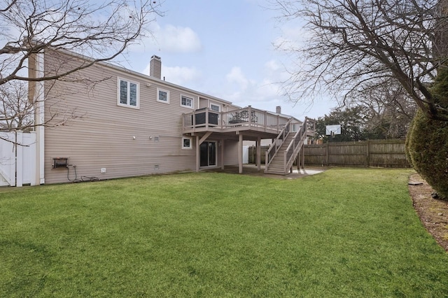 rear view of house with a lawn and a deck