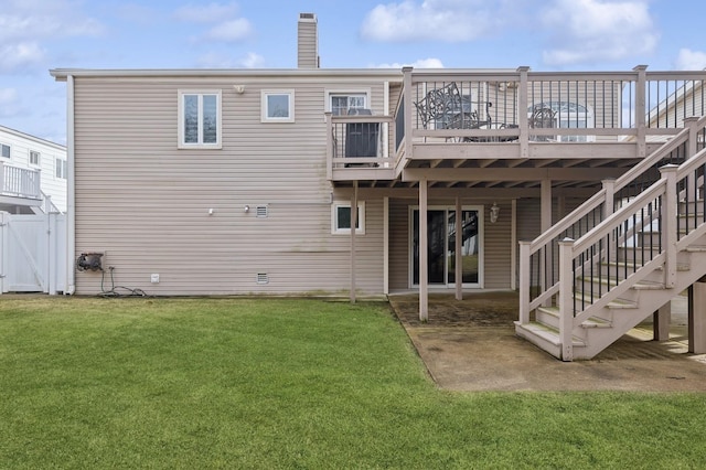 back of house with a deck and a lawn