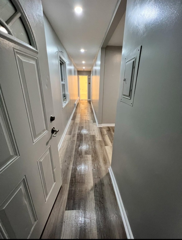 corridor with hardwood / wood-style flooring