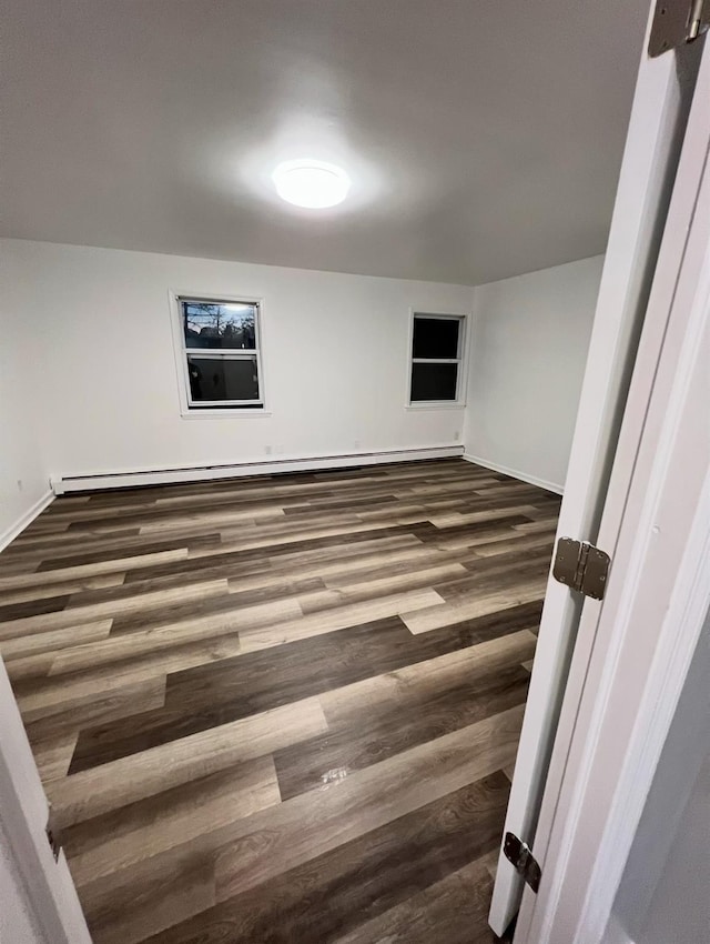 spare room with dark hardwood / wood-style floors