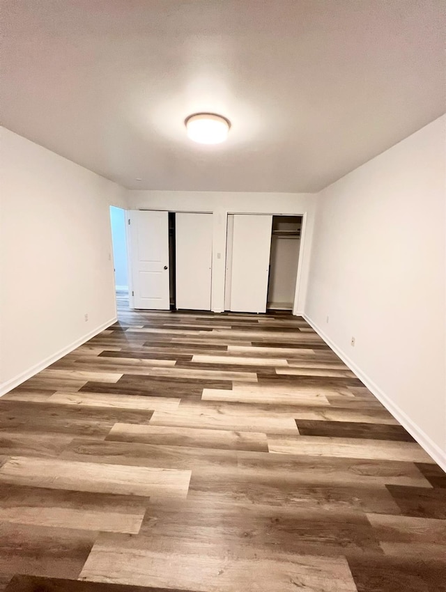 unfurnished bedroom featuring dark hardwood / wood-style floors