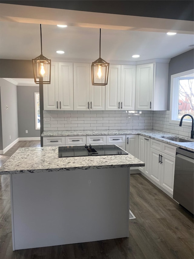 kitchen with white cabinetry, sink, decorative light fixtures, and dishwasher