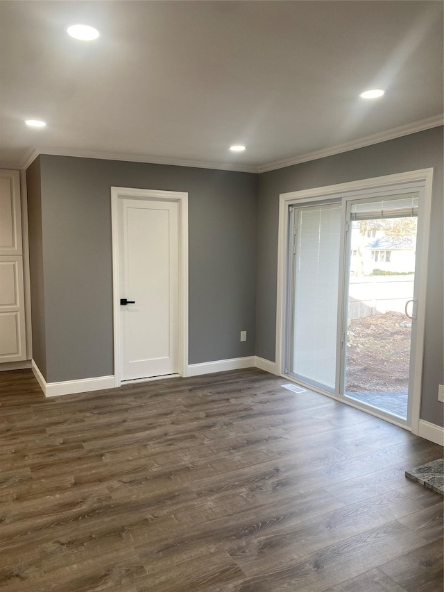 empty room featuring ornamental molding and dark hardwood / wood-style floors